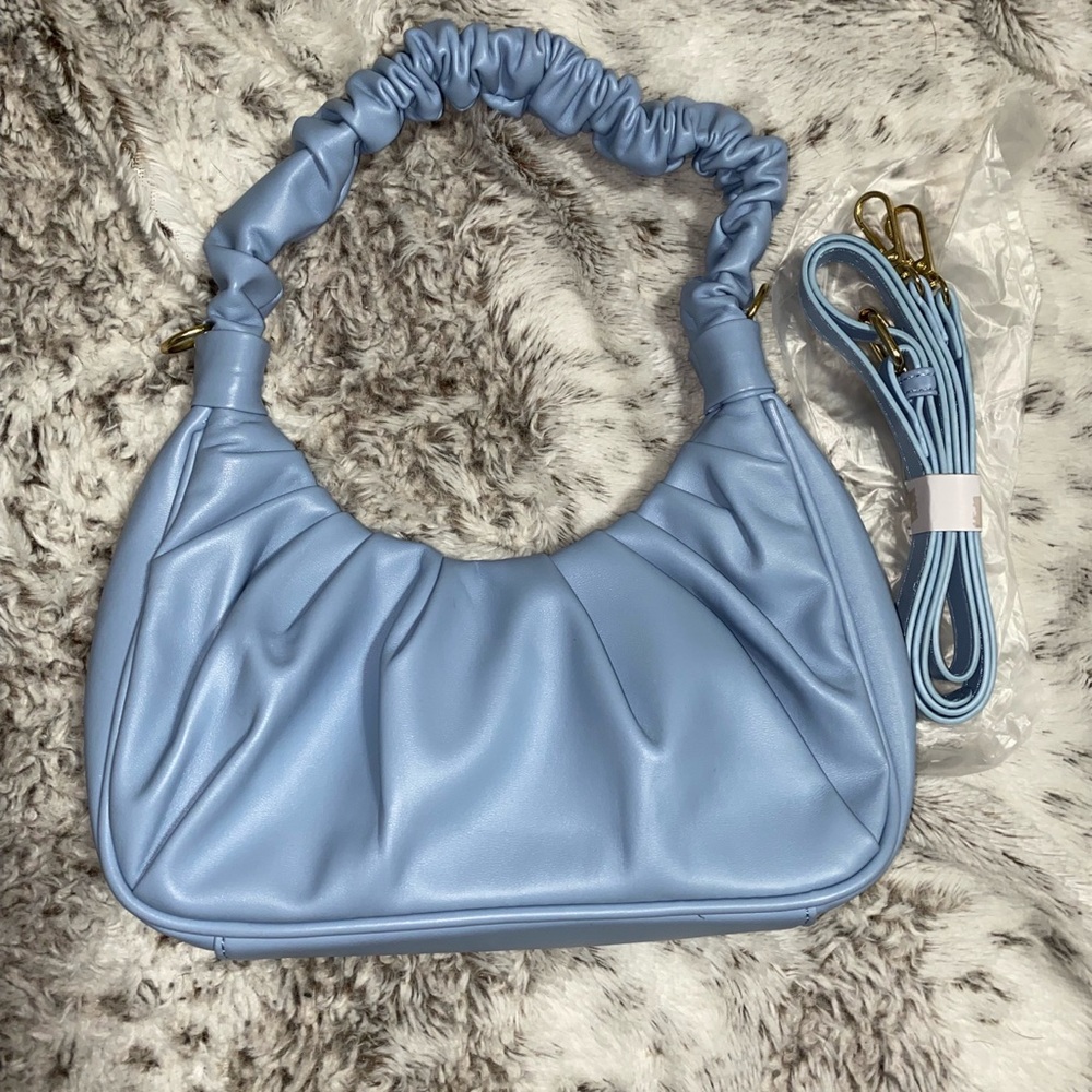 Blue clutch purse with a shoulder strap